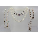 A DOUBLE STRAND OF CULTURED PEARLS, mounted with a 9ct gold set facet cushion cut stone, possibly an