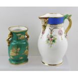 A FRENCH PORCELAIN JUG with moulded mask spout, cast serpent and mask handle, hand-painted floral