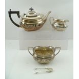 WILLIAM AITKIN AN EDWARDIAN THREE PIECE SILVER TEASET of Georgian fluted design, comprising; teapot,