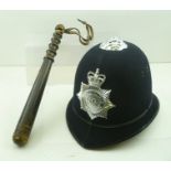 A METROPOLOTAN POLICE HELMET with badge, together with a turned wood truncheon and a "Warwickshire