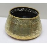 A 19TH CENTURY BRASS ISLAMIC BOWL, having pierced rim over script engraving to the body in the