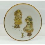 A CHILD'S NURSERY PLATE with applied paper decoration of children, 17cm diameter