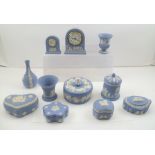 A COLLECTION OF WEDGWOOD CERAMIC ITEMS, includes lidded trinket boxes, vases and two clocks, pale