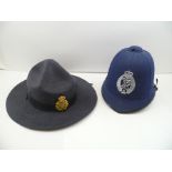 A NEW ZEALAND ISSUE POLICE HELMET with badge, together with a CANADIAN BROAD BRIMMED HAT bearing "