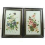 A PAIR OF LATE VICTORIAN FLORAL PAINTINGS ON OPAQUE GLASS PANELS, 40cm x 25cm in dark green coloured