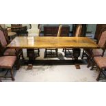 AN ELIZABETHAN DESIGN OAK TRESTLE FORM REFECTORY DINING TABLE, having plank top, raised on carved