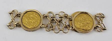 A GOLD BRACELET, set with four sovereigns, dated 1908, two dated 1911 and one dated 1918, the