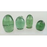 FOUR VICTORIAN GREEN GLASS DUMP PAPERWEIGHTS with inclusions, tallest 11cm high