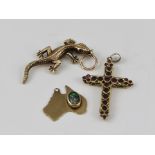 A 9CT GOLD CAST SALAMANDER PENDANT, a stone set 9ct. gold CROSS, and a 9ct. gold PENDANT shaped as