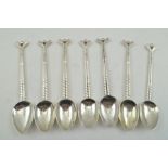 WALKER AND HALL A COLLECTION OF SEVEN VARIOUS SILVER "GOLF" TEA SPOONS, modelled with golf club