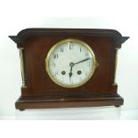 AN EARLY 20TH CENTURY MAHOGANY EIGHT DAY MANTEL CLOCK with brass column mounts, 24cm high