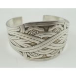 A GEORG JENSEN DANISH SILVER CUFF BANGLE, Art Nouveau band and flower head decoration, various stamp
