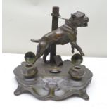 A 20TH CENTURY WELL MODELLED METAL DESK STAND, depicting a fighting dog tethered to a post