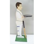 A PAINTED WOOD FIGURE OF A BATSMAN with bat, fashioned as a door butler, height 87cm