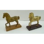 TWO GILT METAL HORSES on wooden bases, 17cm high