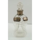 JOHN GRINSELL AND SONS AN EARLY 20TH CENTURY GLASS "GLUG" DECANTER with silver collar, plain glass