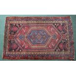 AN IRANIAN 20TH CENTURY PERSIAN RUG, having deep pink ground with stylised decoration, fringed and