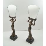 A PAIR OF FRENCH ART DECO DESIGN BRONZED SPELTER FIGURES, raised on ebonized squared wood bases,
