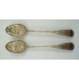 TWO MATCHED GEORGE III SILVER BERRY SPOONS embossed and chased floral decoration, London 1781, 1782,