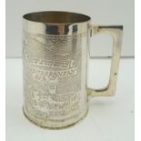 A SILVER PLATED MUG made from the brass and commemorating the North Africa Campaign 1942-1945