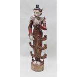 AN INDONESIAN CARVED WOOD FIGURE having polychrome decoration inset with glass and mirror "