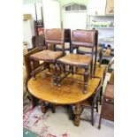 A SET OF EIGHT OAK FRAMED SINGLE DINING CHAIRS, having embossed leather and stud work back and