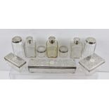 A SELECTION OF VICTORIAN SILVER CAPPED LEAD CRYSTAL VANITY CASE/VALISE BOTTLES AND BOXES, comprising