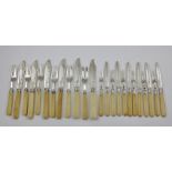 A SET OF SIX VICTORIAN FISH KNIVES AND FORKS, having ivory handles together with a similar set of