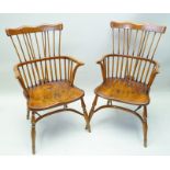 A PAIR OF DOUBLE COMB BACK COUNTRY ARMCHAIRS each with well figured solid seat, supported on