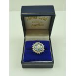 A DIAMOND AND AQUAMARINE CLUSTER RING of flower head design, central diamond approx. half carat, set