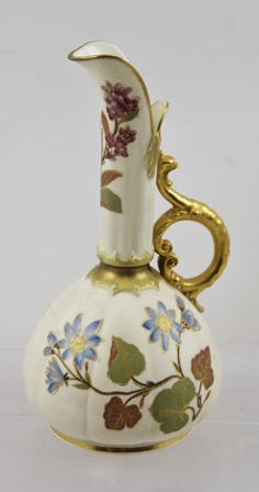 A ROYAL WORCESTER PORCELAIN SMALL CARAFE, having gilt rims, floral neck and belly, with gilt handle,