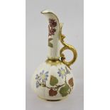 A ROYAL WORCESTER PORCELAIN SMALL CARAFE, having gilt rims, floral neck and belly, with gilt handle,