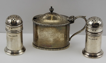 A PAIR OF GEORGIAN DESIGN SILVER PEPPERS, Birmingham 1927, together with an oval MUSTARD POT of