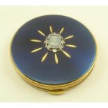 A "MARGARET ROSE" POWDER COMPACT, in brass case with hinged blue cover inset cameo design decoration