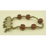 AN EASTERN, POSSIBLY BEDOUIN NECKLACE, set cube form dark red beads, possibly amber