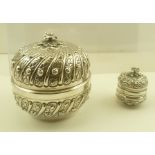 TWO EASTERN WHITE METAL BOXES with domed covers, having cast floral finials and gilded interiors,