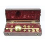 AN EARLY VICTORIAN SYKES HYDROMETER, having nine weights, in original mahogany box with two