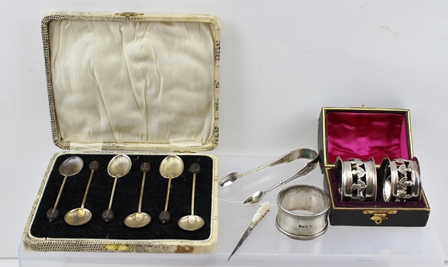 A COLLECTION OF SILVER ITEMS, comprising six bean terminal coffee spoons (cased), a pair of napkin