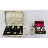 A COLLECTION OF SILVER ITEMS, comprising six bean terminal coffee spoons (cased), a pair of napkin