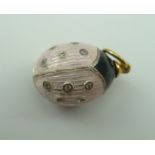A RUSSIAN PENDANT EGG, pink and black enamel, decorated as a Ladybird style insect, stone inset, the