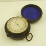 AN EARLY 19TH CENTURY POCKET BAROMETER, calibrated, silvered dial in a fabric lined Morocco