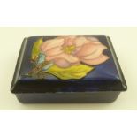 A MOORCROFT CERAMIC TRINKET BOX, of rectangular form, the lid tube lined and painted with a magnolia