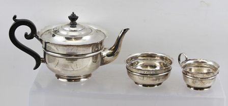 SHERWOOD & SONS A THREE-PIECE SILVER TEA SET, having cut and shaped rim banded plain belly, black