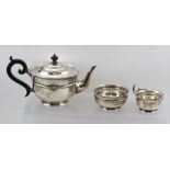 SHERWOOD & SONS A THREE-PIECE SILVER TEA SET, having cut and shaped rim banded plain belly, black