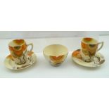 CLARICE CLIFF BIZARRE - A PAIR OF COFFEE CUPS AND SAUCERS together with a SUGAR BOWL, hand-painted