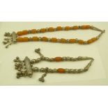 TWO DECORATIVE NECKLACES, possibly Bedouin, white metal and bead, possibly amber