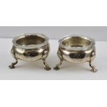 DAVID HENNELL A PAIR OF MID 18TH CENTURY SALTS of circular form, raised on three feet, dated 1752,