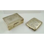 E**A**W** A RECTANGULAR SILVER CIGARETTE BOX having engine turned decorated hinged lid and plain