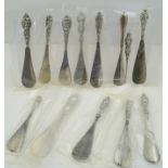 A COLLECTION OF TWELVE SILVER HANDLED STEEL SHOE HORNS, with pressed foliate and floral