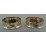 HERSEY & SON LTD. A PAIR OF MODERN SILVER COASTERS, each having a plain applied rim, geometric